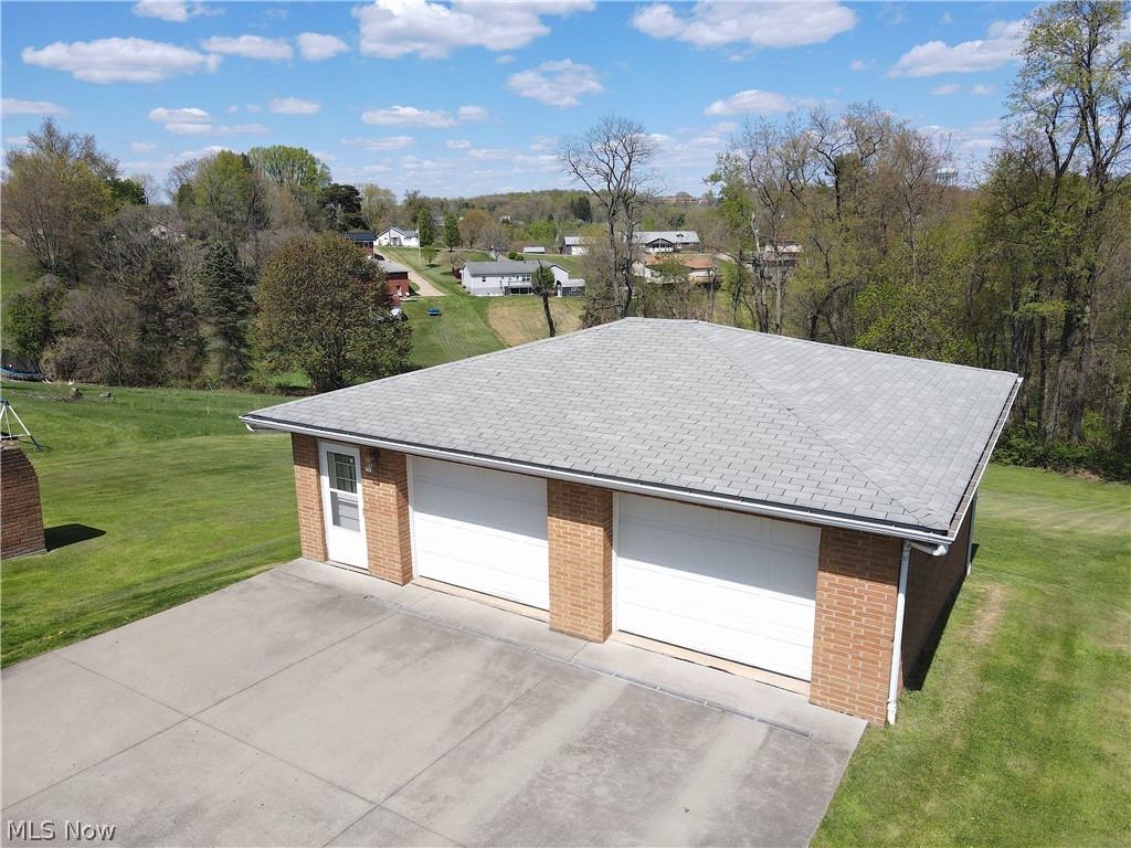 Garage featuring a lawn