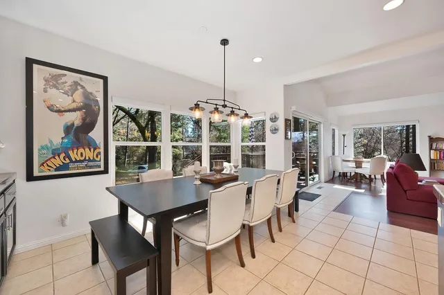 a dining room with furniture a painting and a chandelier