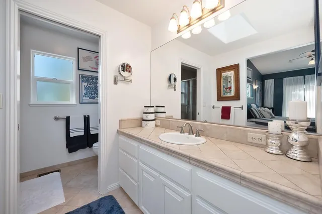 a bathroom with a double vanity sink and a mirror