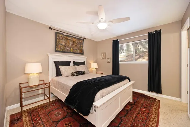 a bedroom with bed and a night stand