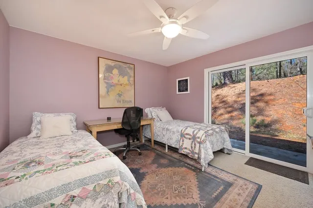 a bedroom with a bed and a large window