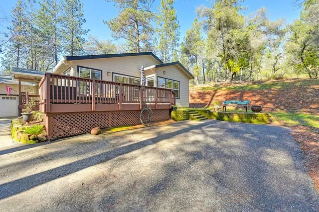 a view of a house with wooden deck