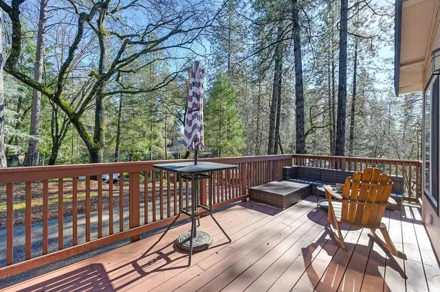 a view of balcony with wooden floor and outdoor seating