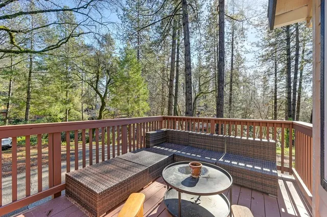 a view of a balcony with wooden floor and chairs