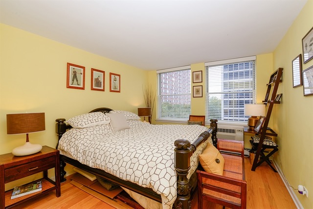 3033 North Sheridan Road, Unit 701 Chicago, IL 60657 - Photo 7 of 13 a bedroom with a bed and wooden floor