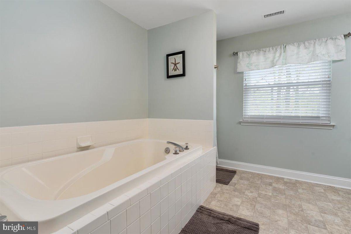 840 West Mount Harmony Road Owings, MD 20736 - Photo 16 of 38 Primary bathroom with sunken tub and sep. shower