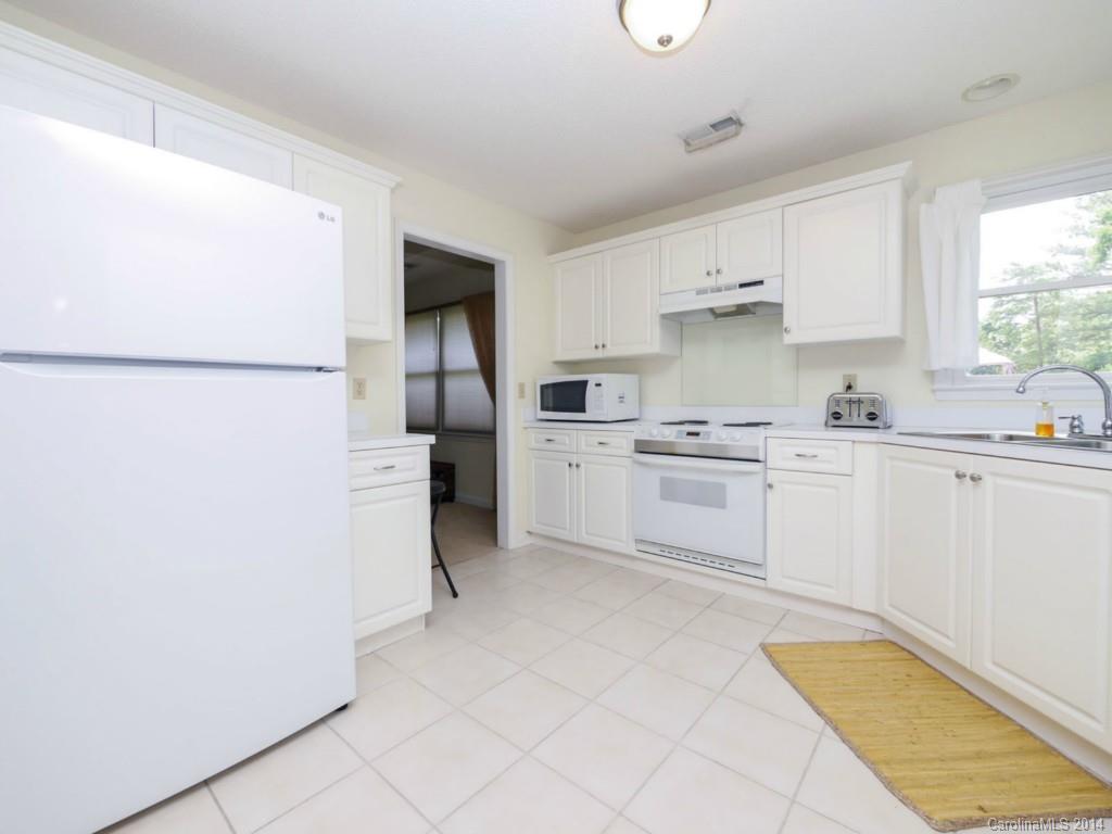 708 Monticello Drive Fort Mill, SC 29708 - Photo 11 of 22 a kitchen with white cabinets and white appliances