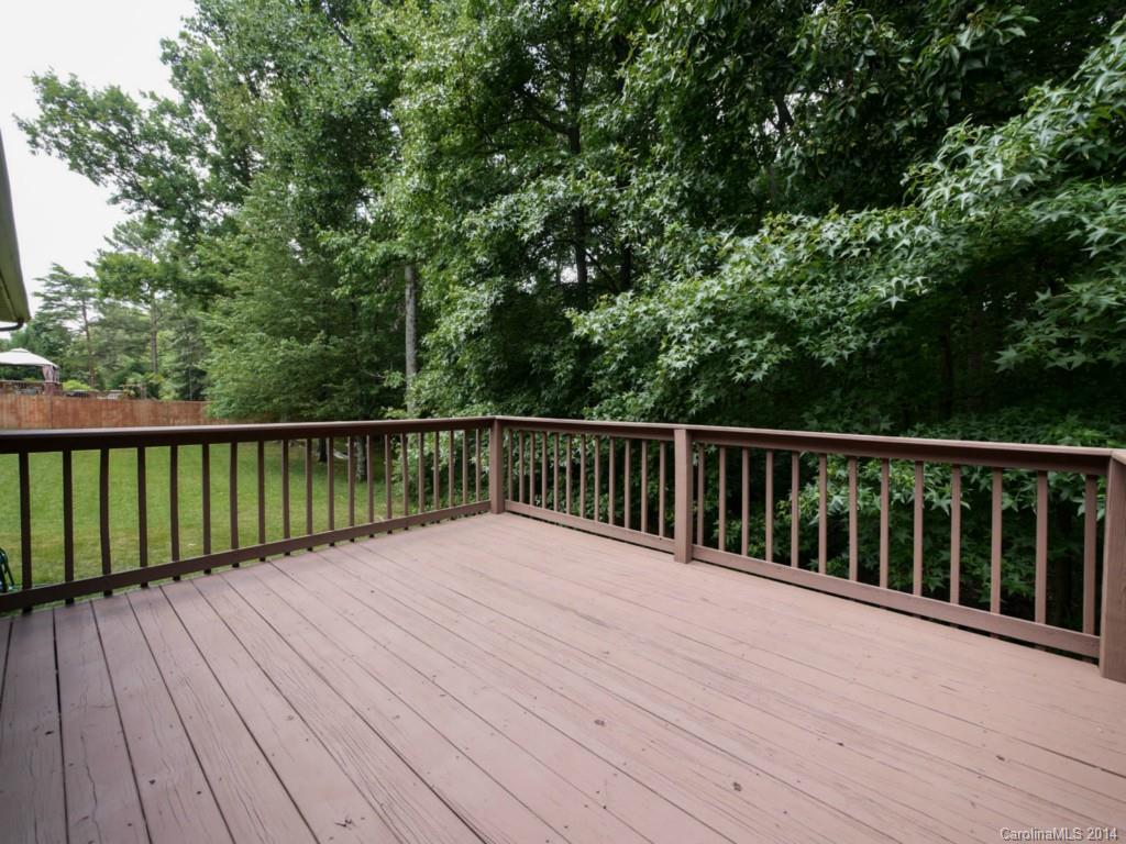 708 Monticello Drive Fort Mill, SC 29708 - Photo 19 of 22 a balcony with wooden floor and trees in the background