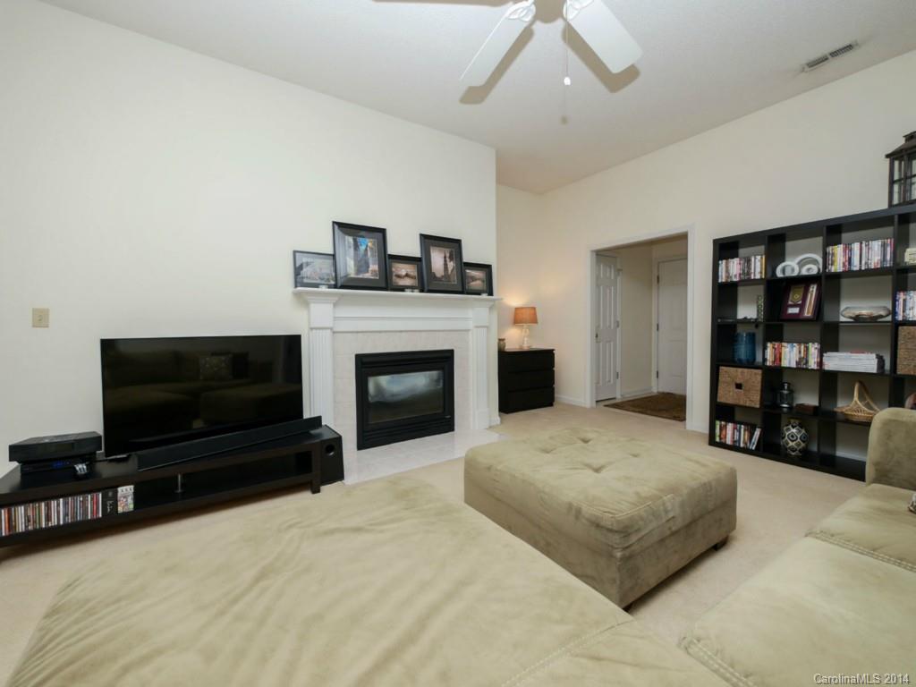 708 Monticello Drive Fort Mill, SC 29708 - Photo 4 of 22 a living room with furniture a flat screen tv and a fireplace
