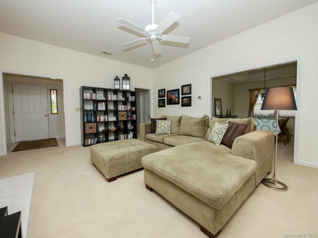 708 Monticello Drive Fort Mill, SC 29708 - Photo 5 of 22 a living room with furniture cabinets and a ceiling fan
