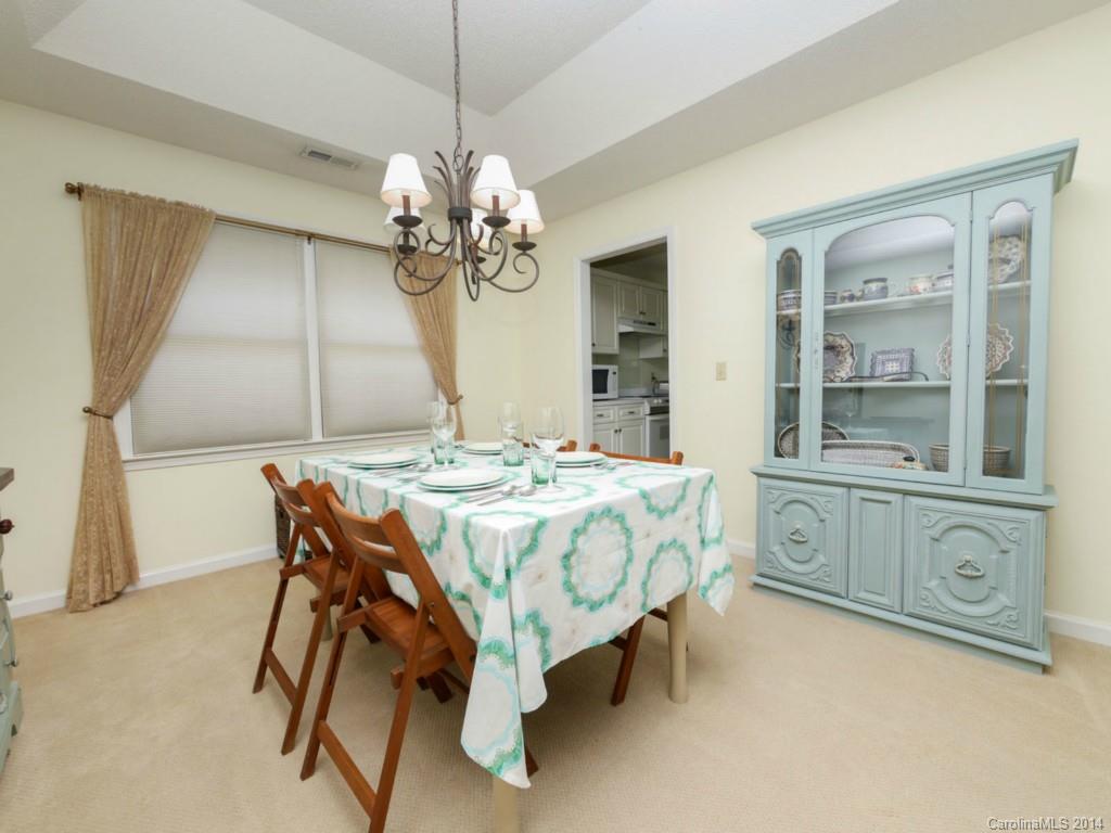 708 Monticello Drive Fort Mill, SC 29708 - Photo 7 of 22 a dining room with wooden floor a chandelier a wooden table and chairs