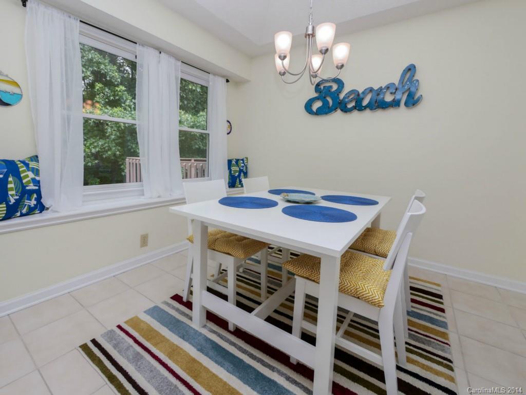708 Monticello Drive Fort Mill, SC 29708 - Photo 8 of 22 a view of a dining room with furniture a rug and wooden floor