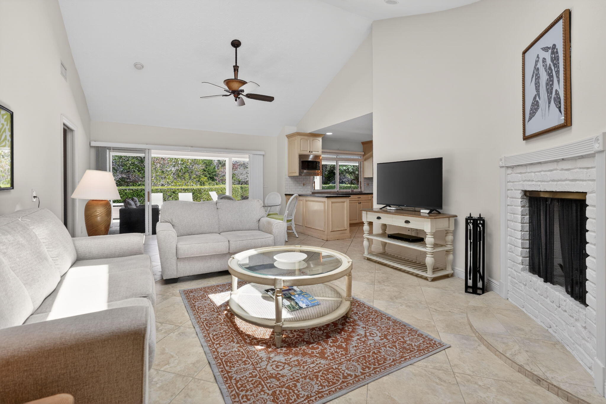 5741 Southeast Winged Foot Drive Stuart, FL 34997 - Photo 12 of 58 a living room with furniture a fireplace and a flat screen tv