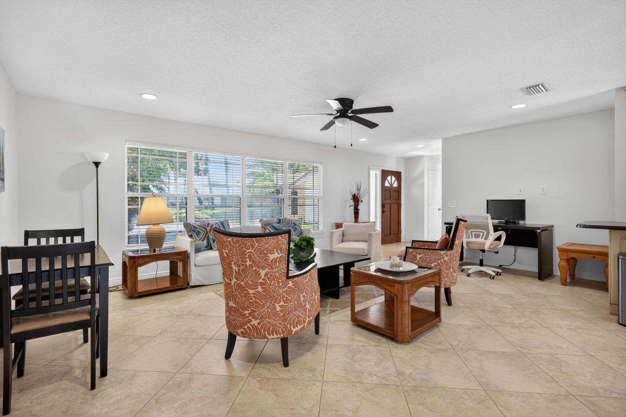 5741 Southeast Winged Foot Drive Stuart, FL 34997 - Photo 3 of 58 a living room with furniture and a flat screen tv