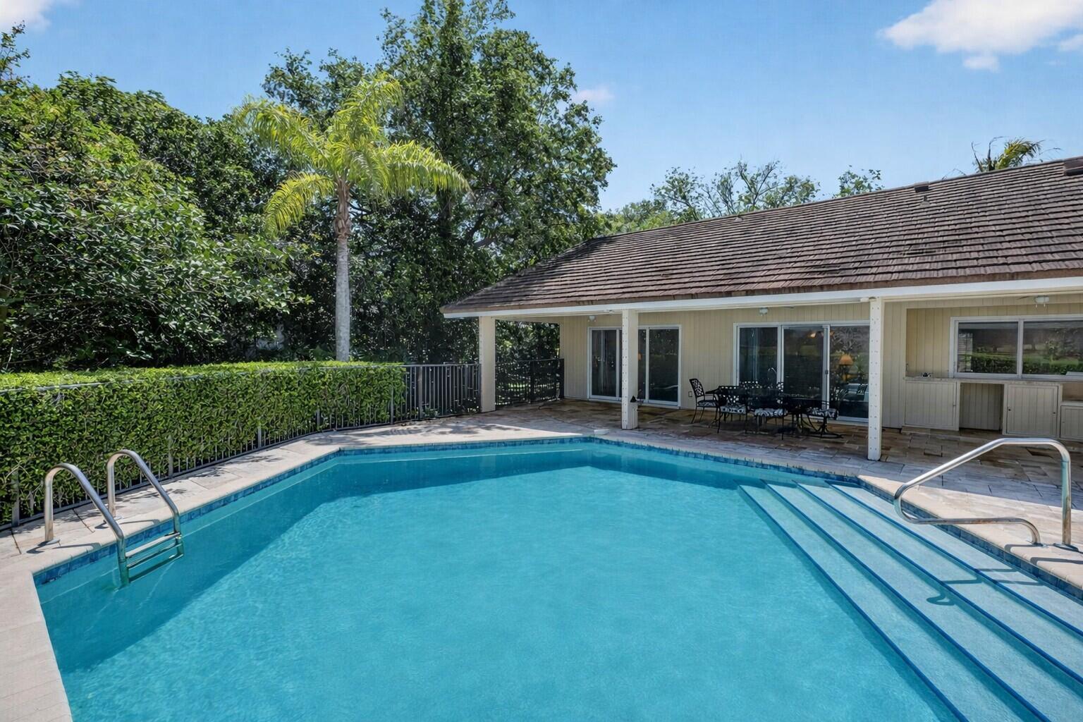 5741 Southeast Winged Foot Drive Stuart, FL 34997 - Photo 34 of 58 a view of house and outdoor space with swimming pool and yard
