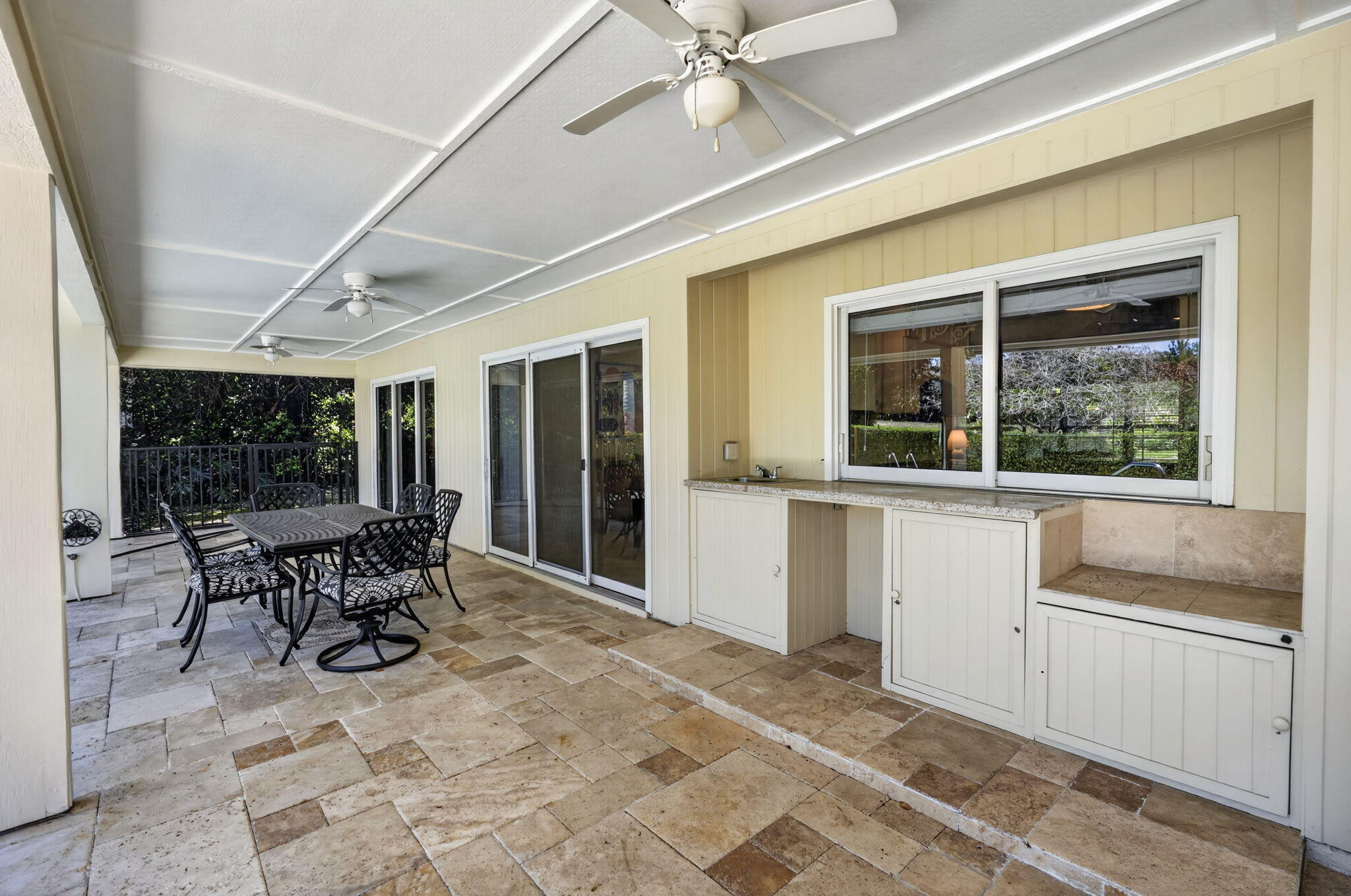 5741 Southeast Winged Foot Drive Stuart, FL 34997 - Photo 37 of 58 a view of a building with chairs and table in front of a window