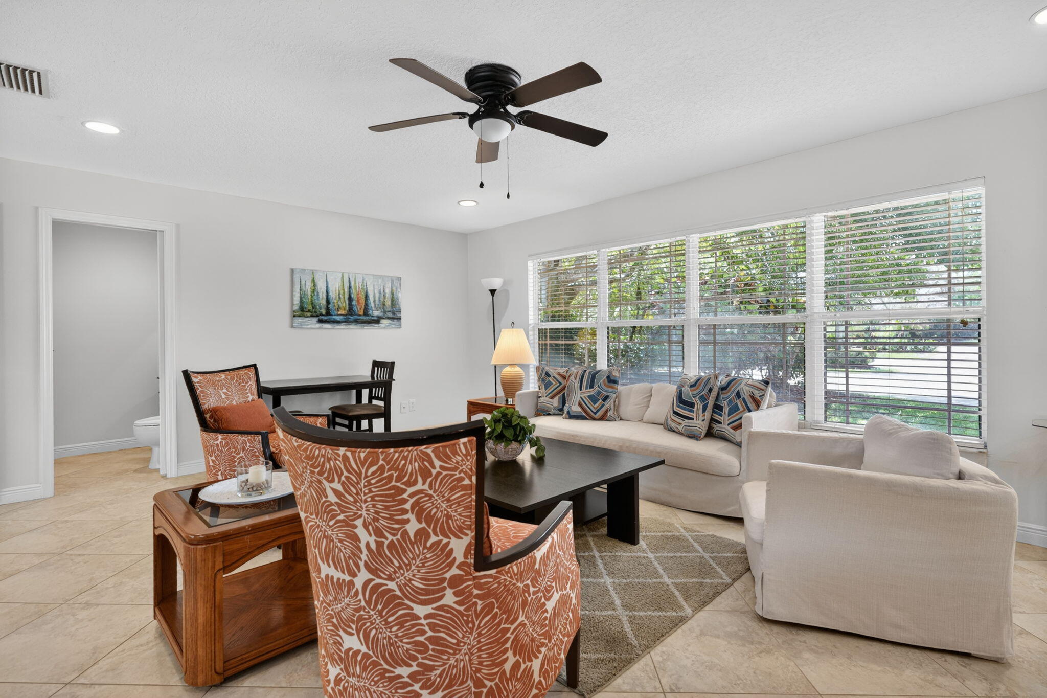 5741 Southeast Winged Foot Drive Stuart, FL 34997 - Photo 4 of 58 a living room with furniture and a large window