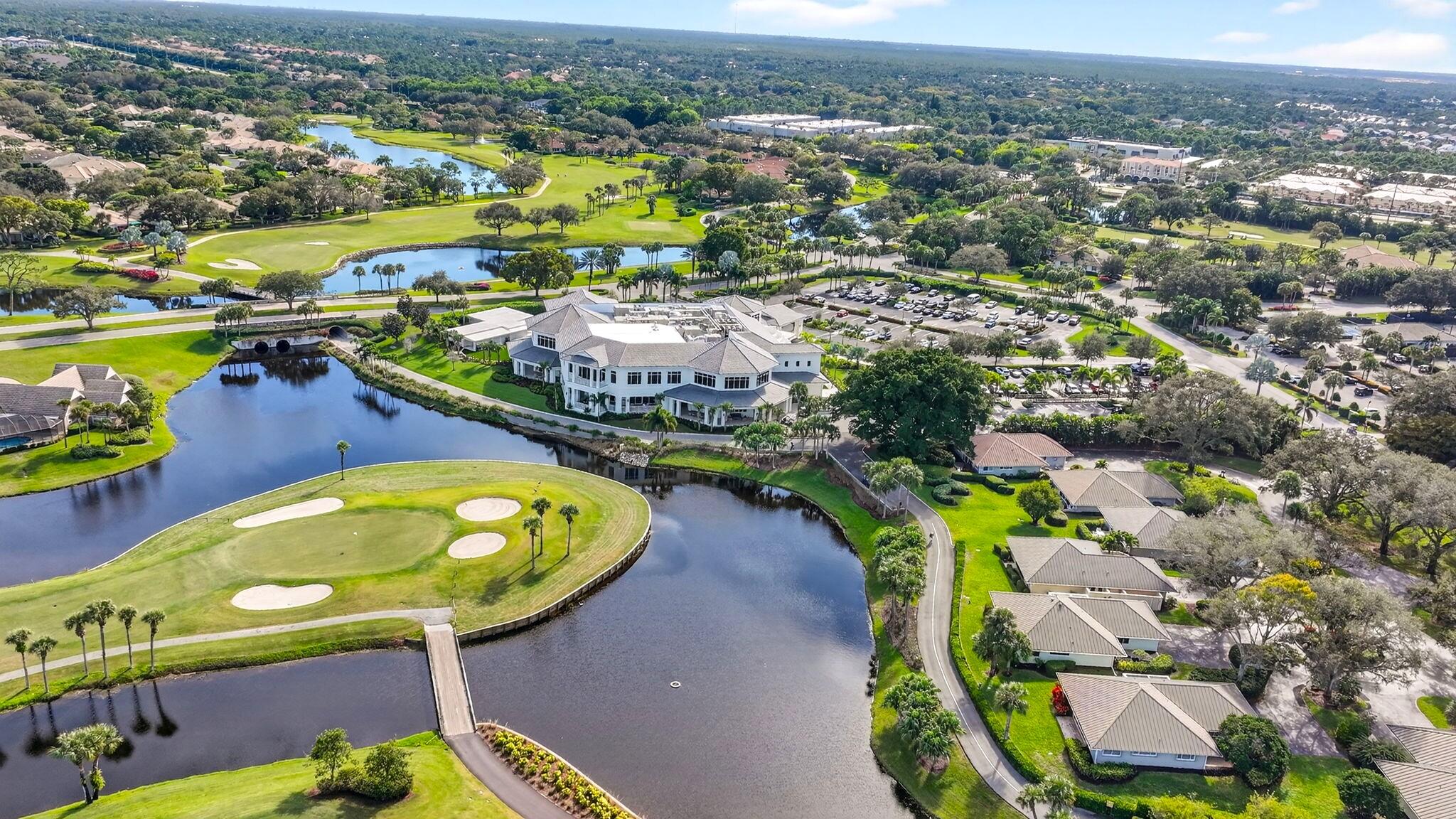 5741 Southeast Winged Foot Drive Stuart, FL 34997 - Photo 42 of 58 an aerial view of a swimming pool yard and mountain view in back