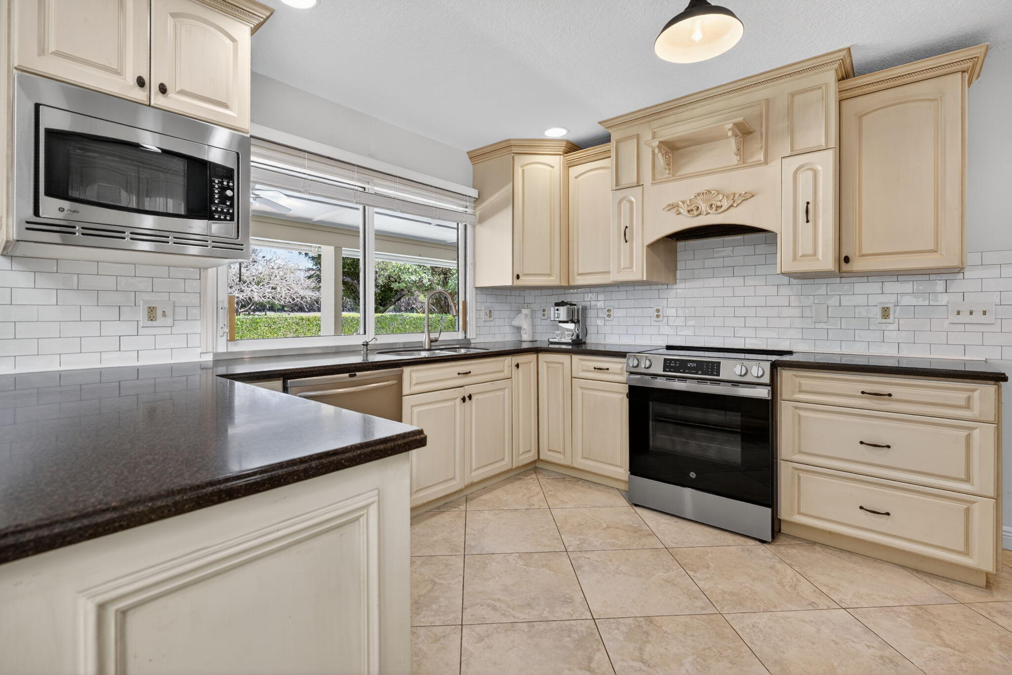 5741 Southeast Winged Foot Drive Stuart, FL 34997 - Photo 6 of 58 a kitchen with cabinets appliances and a sink