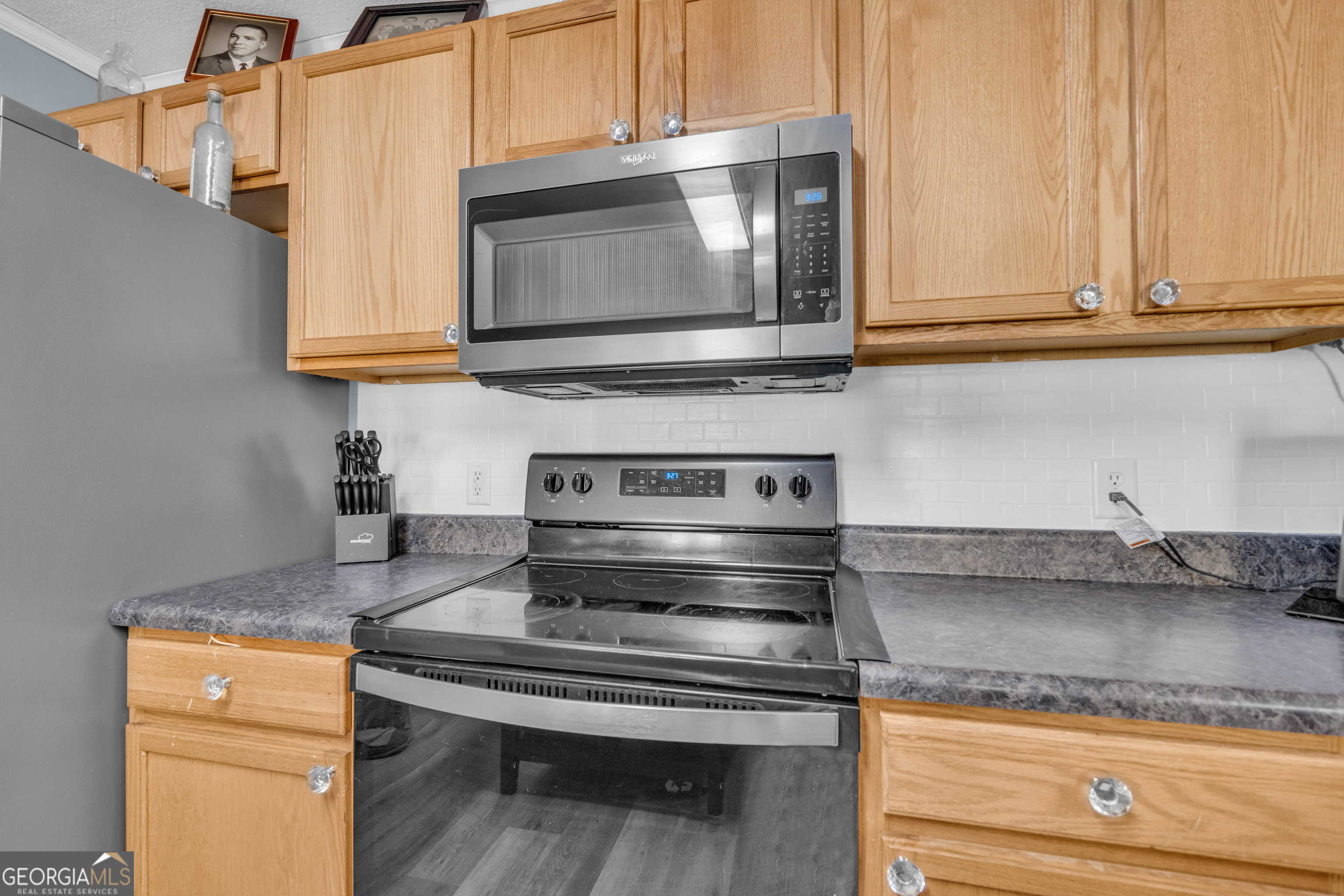 748 West Vincent Drive Athens, GA 30607 - Photo 8 of 18 a kitchen with granite countertop a stove and a microwave