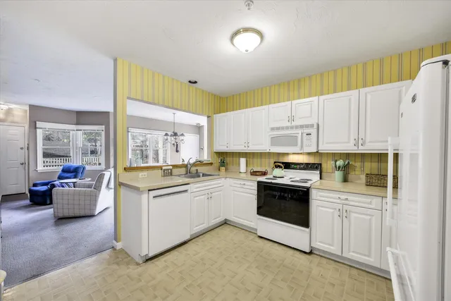 a kitchen with stainless steel appliances granite countertop a stove and more cabinets