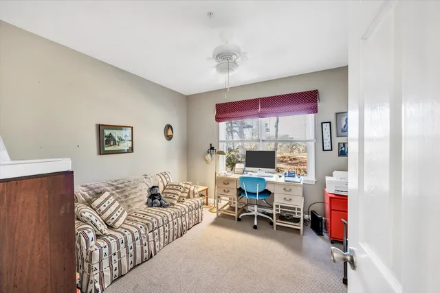 a bedroom with furniture and a large window