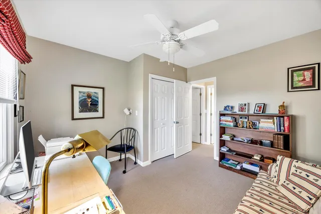 a living room with lots of furniture and a book shelf