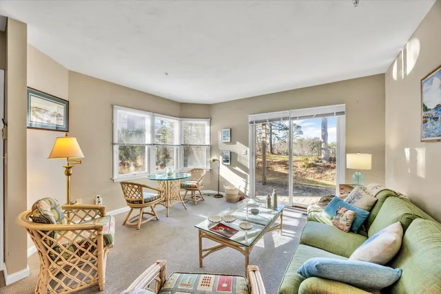 a living room with furniture and a lamp