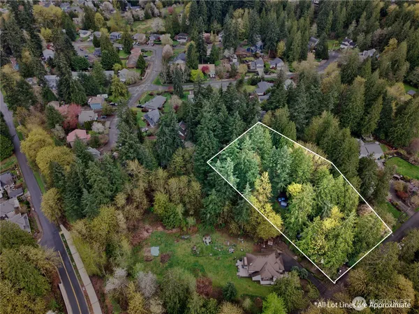 an aerial view of residential house with outdoor space and trees all around