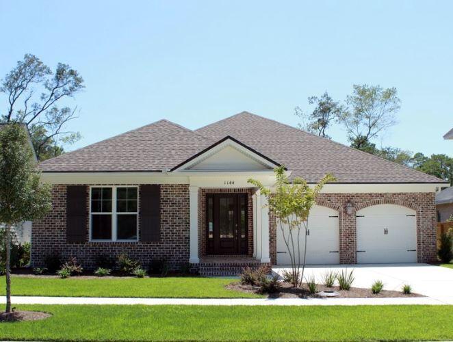 1144 Deer Moss Loop Niceville, FL 32578 - Photo 1 of 11 a front view of a house with a yard and garage