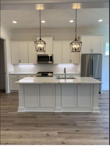1144 Deer Moss Loop Niceville, FL 32578 - Photo 4 of 11 a kitchen with kitchen island granite countertop stainless steel appliances sink cabinets and window