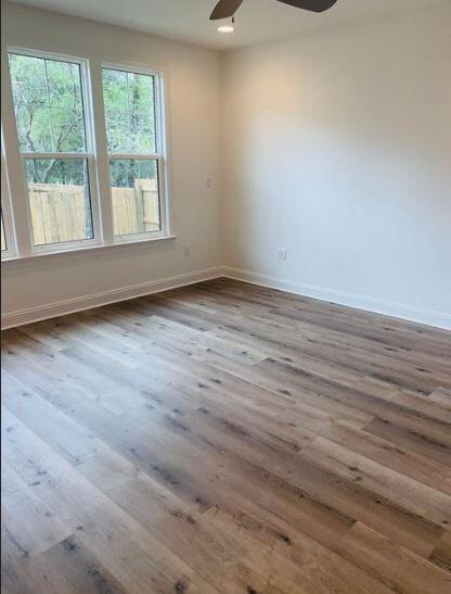 1144 Deer Moss Loop Niceville, FL 32578 - Photo 6 of 11 an empty room with wooden floor and windows