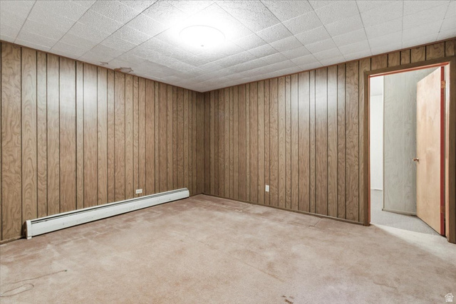 217 East 400 South Spring City, UT 84662 - Photo 37 of 71 Unfurnished room featuring light carpet, a baseboard radiator, and wooden walls