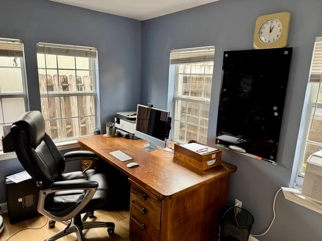 an empty room with windows and closet