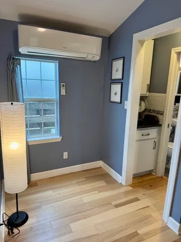 a view of a livingroom with wooden floor and furniture