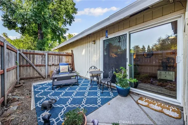 a backyard of a house with barbeque oven table and chairs