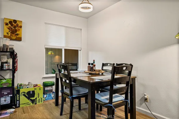 a view of a dining room with furniture and a window