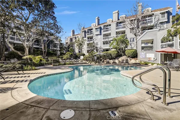 a view of a swimming pool with outdoor seating and plants