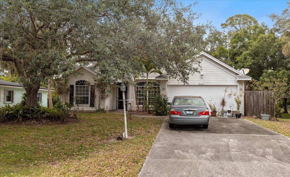 8006 Eden Road Fort Pierce, FL 34951 - Photo 1 of 25 a car parked in front of a house