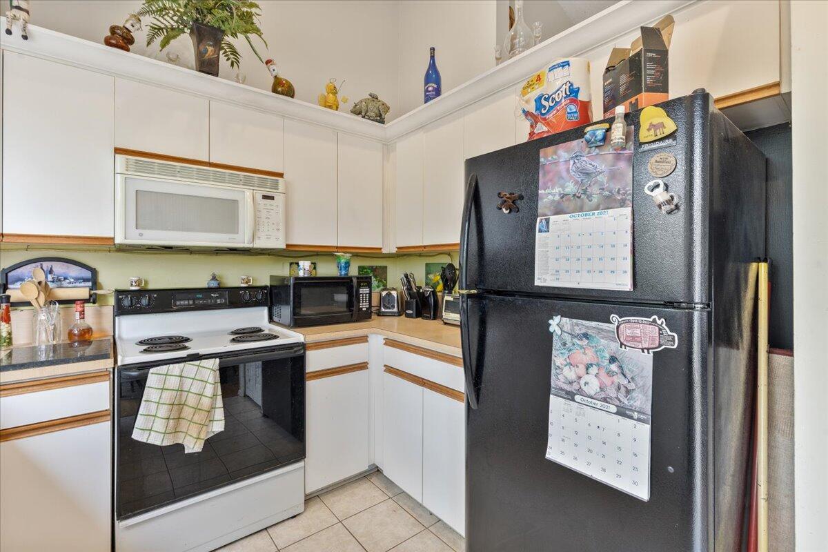 8006 Eden Road Fort Pierce, FL 34951 - Photo 10 of 25 a kitchen with stainless steel appliances granite countertop a stove and a microwave