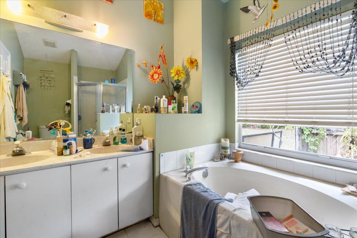 8006 Eden Road Fort Pierce, FL 34951 - Photo 19 of 25 a bathroom with a granite countertop sink and a large mirror