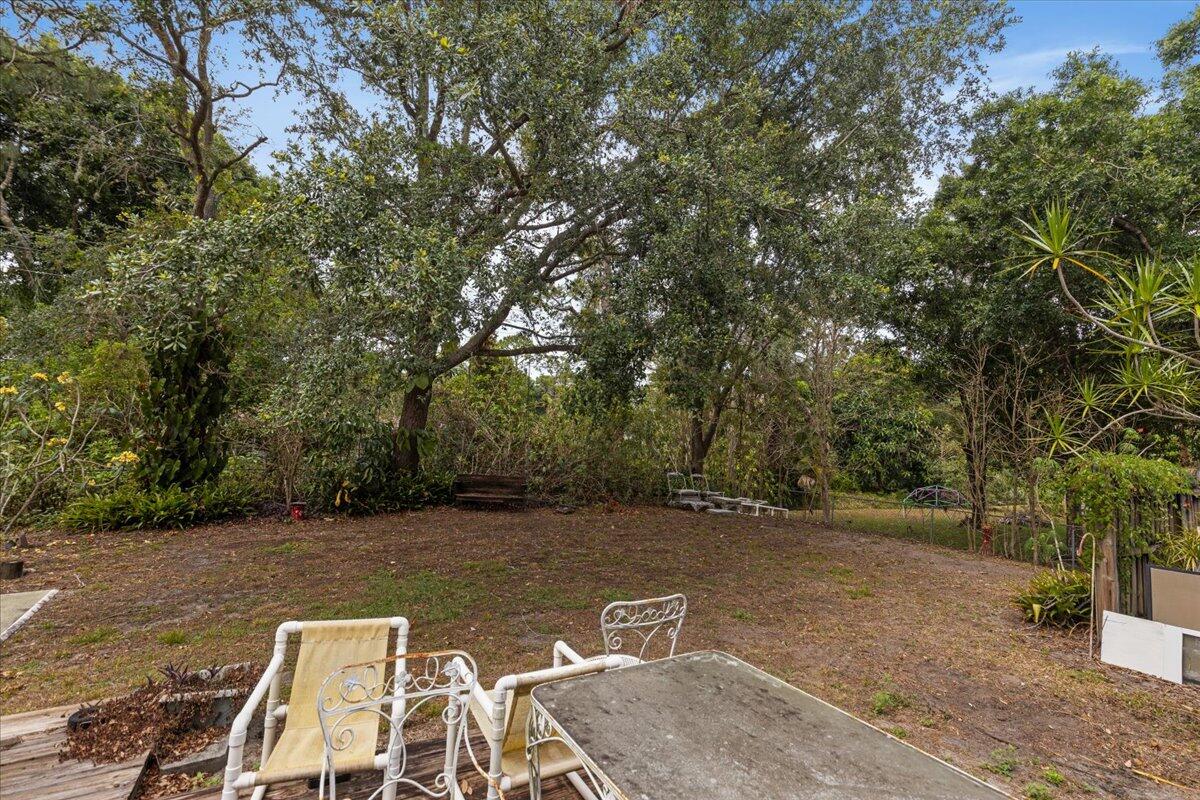 8006 Eden Road Fort Pierce, FL 34951 - Photo 23 of 25 a view of a backyard with large trees