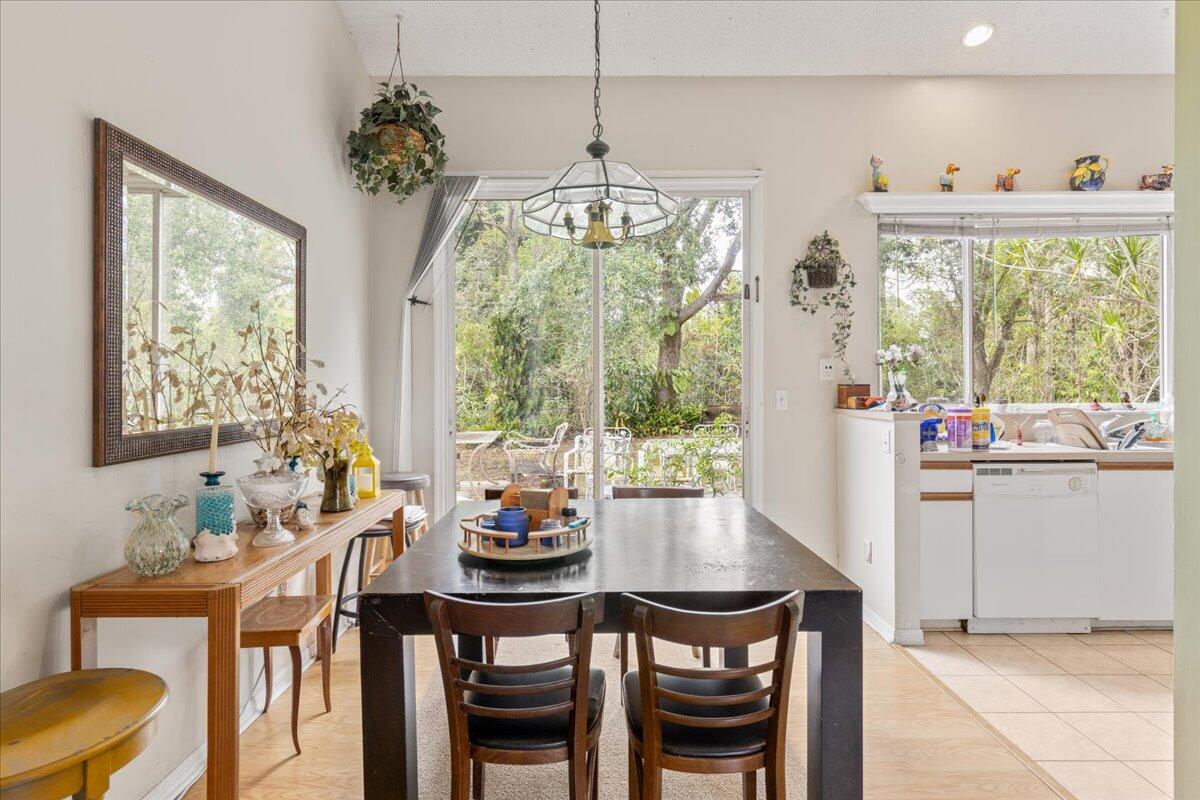 8006 Eden Road Fort Pierce, FL 34951 - Photo 7 of 25 a dining room with furniture a chandelier and wooden floor