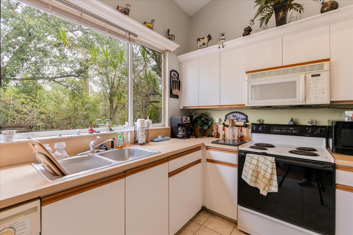 8006 Eden Road Fort Pierce, FL 34951 - Photo 9 of 25 a kitchen with a sink appliances cabinets and a window