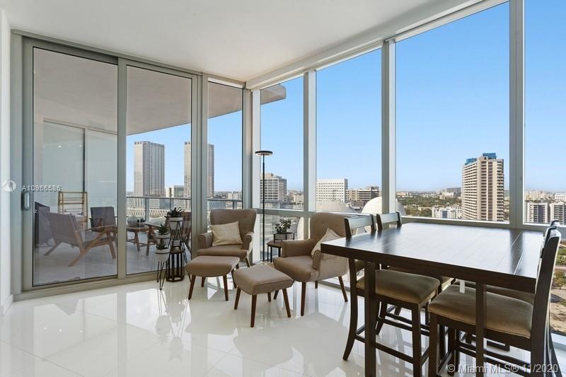 a view of a city from a dining room with furniture