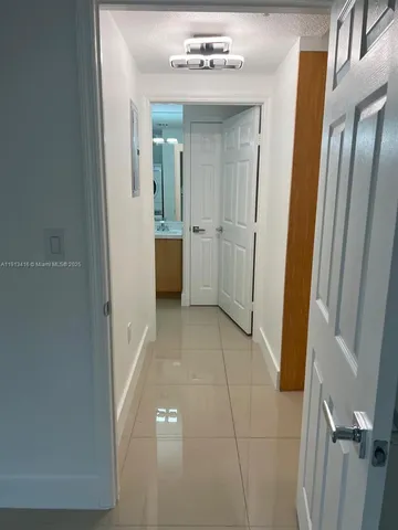 a view of a hallway with a bathroom