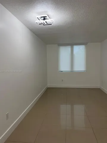 an empty room with a empty space and windows
