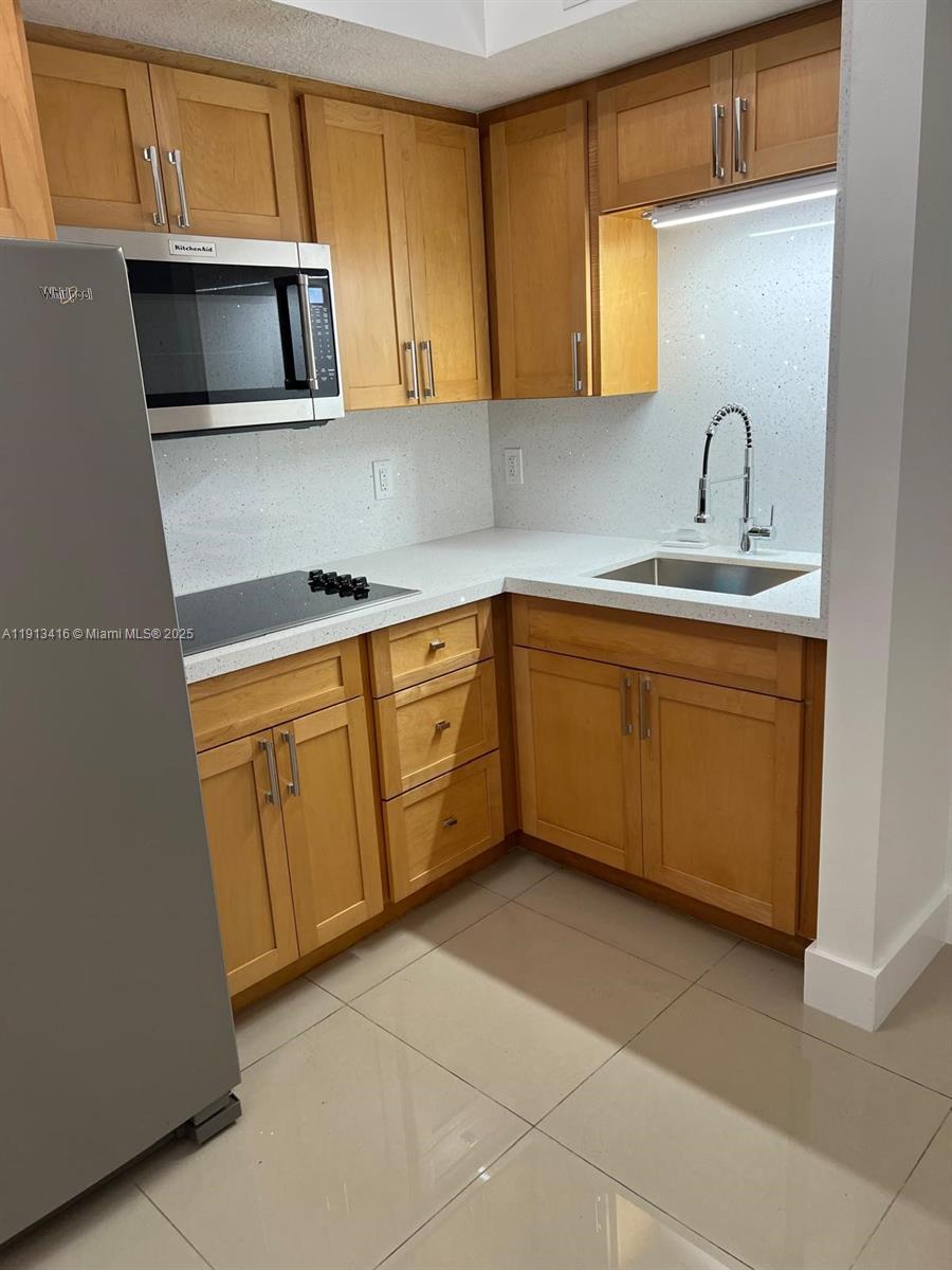 2630 Southwest 28th Street, Unit 40 Miami, FL 33133 - Photo 5 of 16 a kitchen with a sink and cabinets