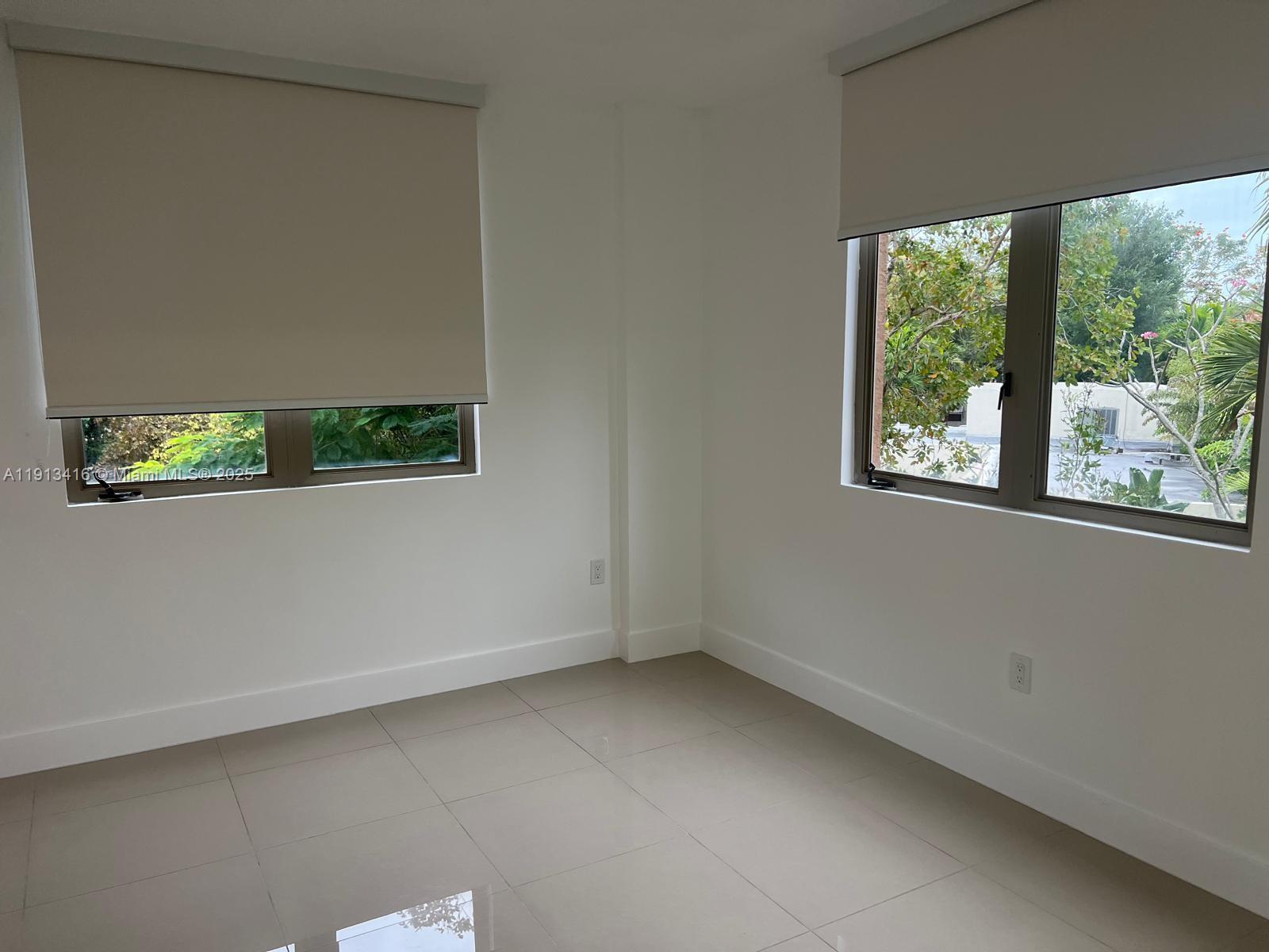 2630 Southwest 28th Street, Unit 40 Miami, FL 33133 - Photo 6 of 16 an empty room with a window
