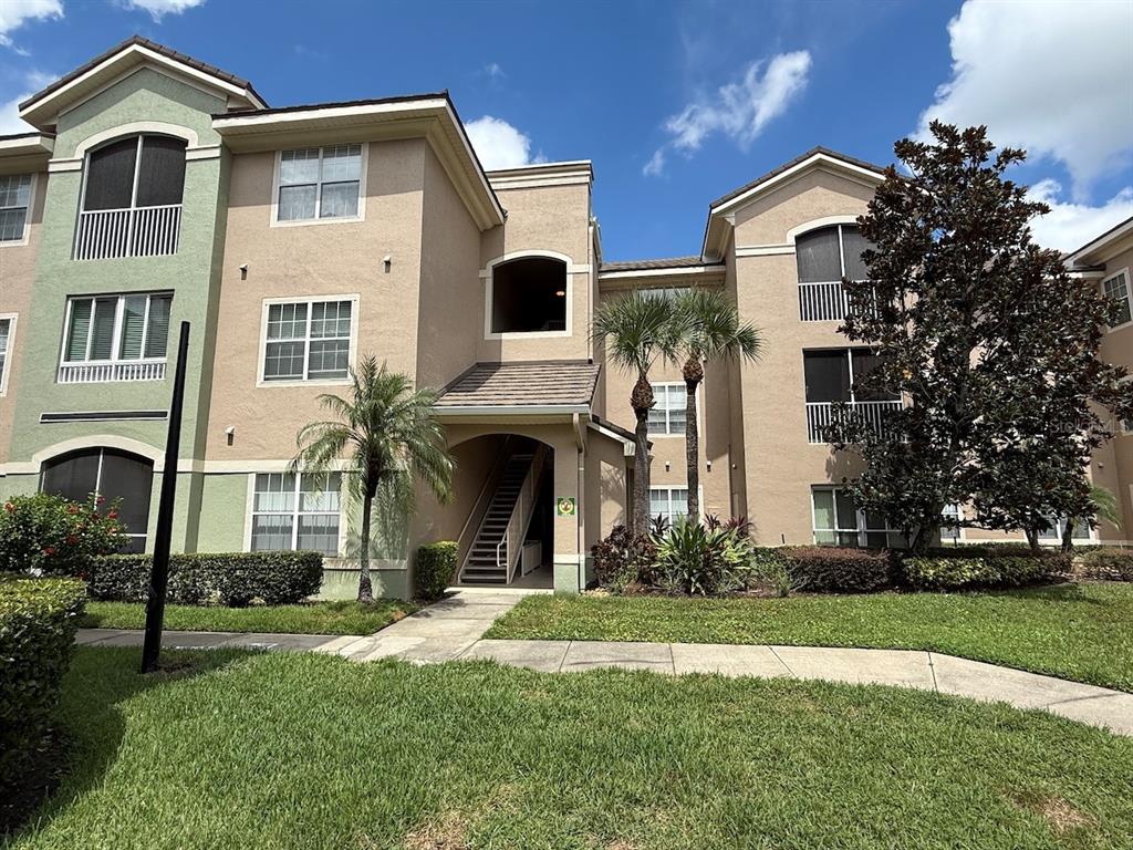 4817 Cypress Woods Drive, Unit 5203 Orlando, FL 32811 - Photo 1 of 22 a front view of a house with a yard